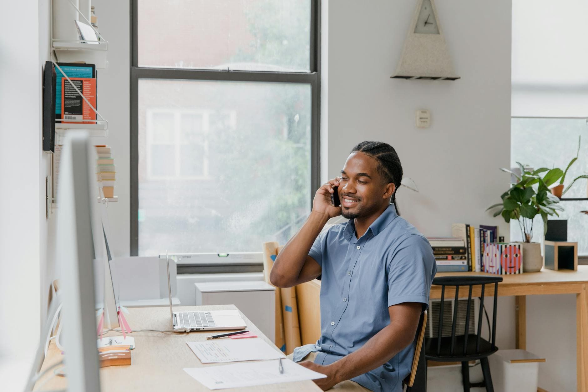 Small business owner handling calls at a desk